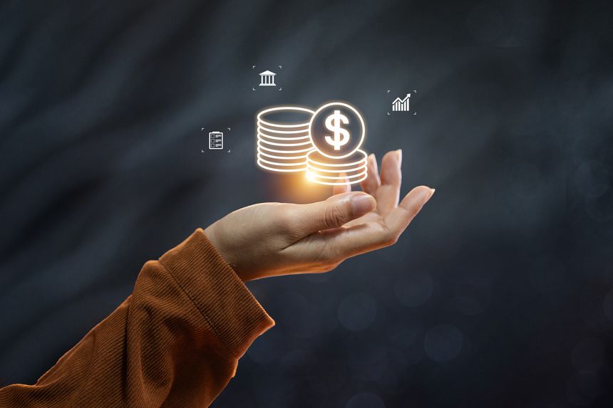 A hand holding a glowing icon of stacked coins, representing digital banking, savings, and financial wealth management.