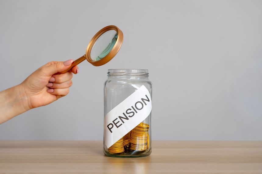 Bank of coins and the inscription Pension. Saving money and retirement concept. Accumulation of pension contributions. Business and finance. Magnifying glass