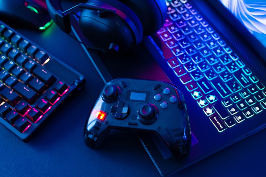 gamer work space concept, top view a gaming gear, mouse, keyboard, joystick on black table background.