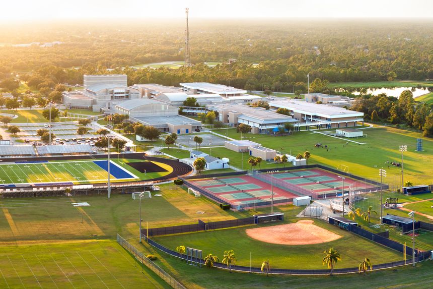 Sports facilities at public school in North Port, Florida. American football stadium, tennis court and baseball diamond sport infrastructure.