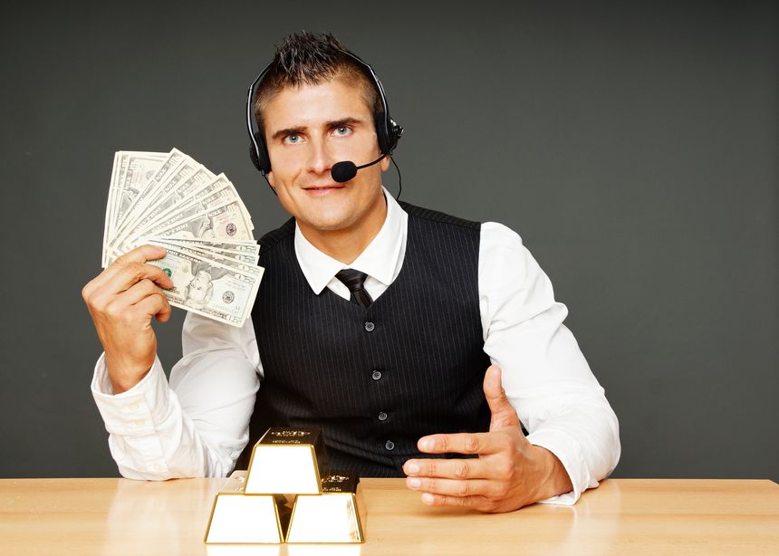Young businessman operator shows you money and showing on the gold bricks