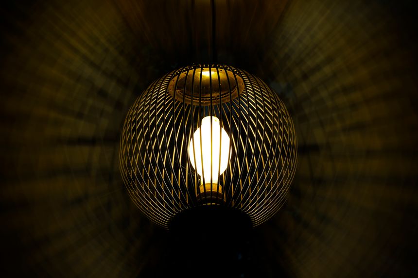 Bright white light and golden illuminated circular lattice shade exterior light and luminous image processing texture spreading around it (Retouched and color manipulated image)