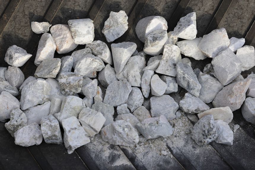 Mining of lithium. Spodumene hard rock ore on conveyor belt. Processed into spodumene concentrate 6 or SC6, for subsequent production of lithium-ion batteries