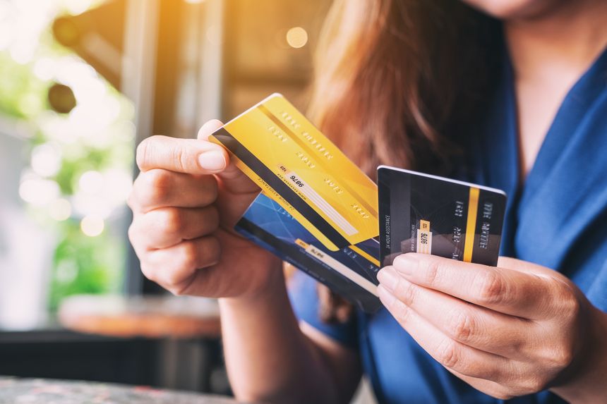 Closeup image of a woman holding and choosing credit card to use