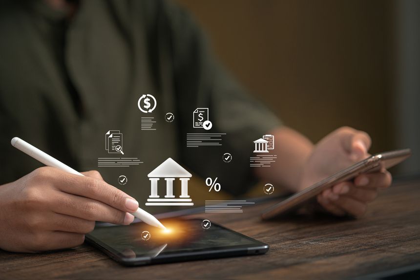 Hand using stylus on tablet with digital banking icons, representing finance management, mobile banking, transactions, and secure payment in technology.