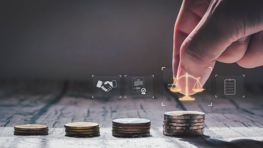 A hand stacking coins beside justice scale icons, symbolizing financial growth, investment fairness, and legal business decisions in a professional setting.