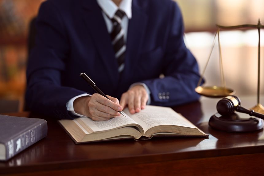 criminal lawyers or male attorney read law books and legal documents at law firm. jurisprudence, law justice education concept.