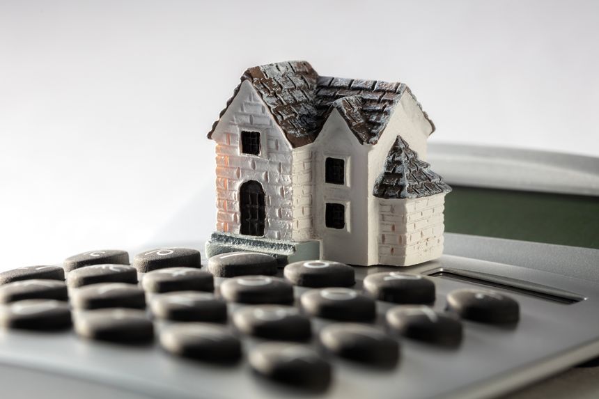 House on calculator concept for mortgage calculator, home finance or saving for a house loan