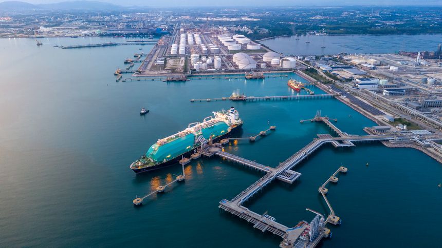 LNG (Liquified Natural Gas) tanker anchored in Gas terminal gas tanks for storage. Oil Crude Gas Tanker Ship. LPG at Tanker Bay Petroleum Chemical or Methane freighter export import transportation