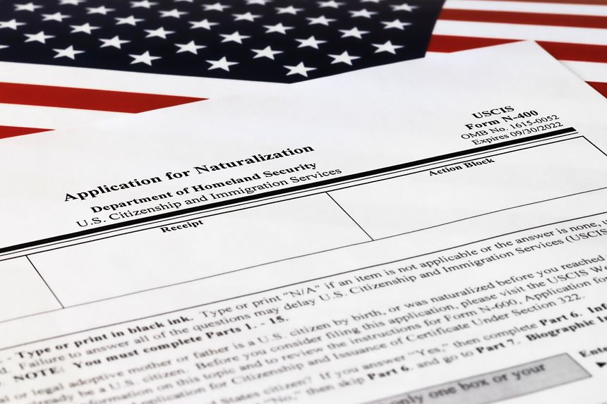 selective focus photo of n-400 form. application for naturalization, on a background of United States flag.