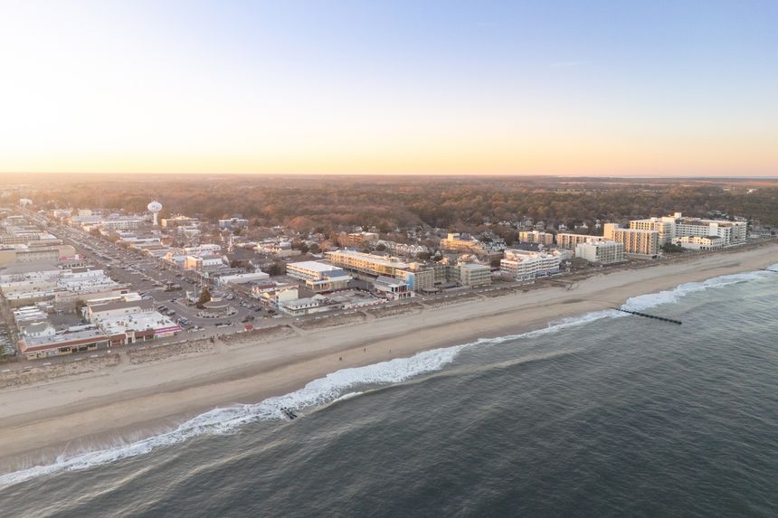 The view north along the coast of Rehoboth Beach, Delaware during sunset