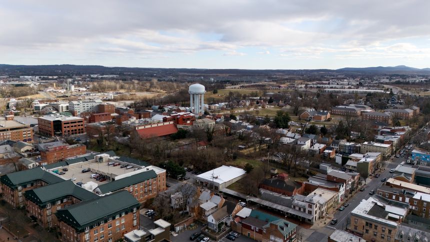 Aerial view of town buildings and residential area with water tower in Frederick Maryland