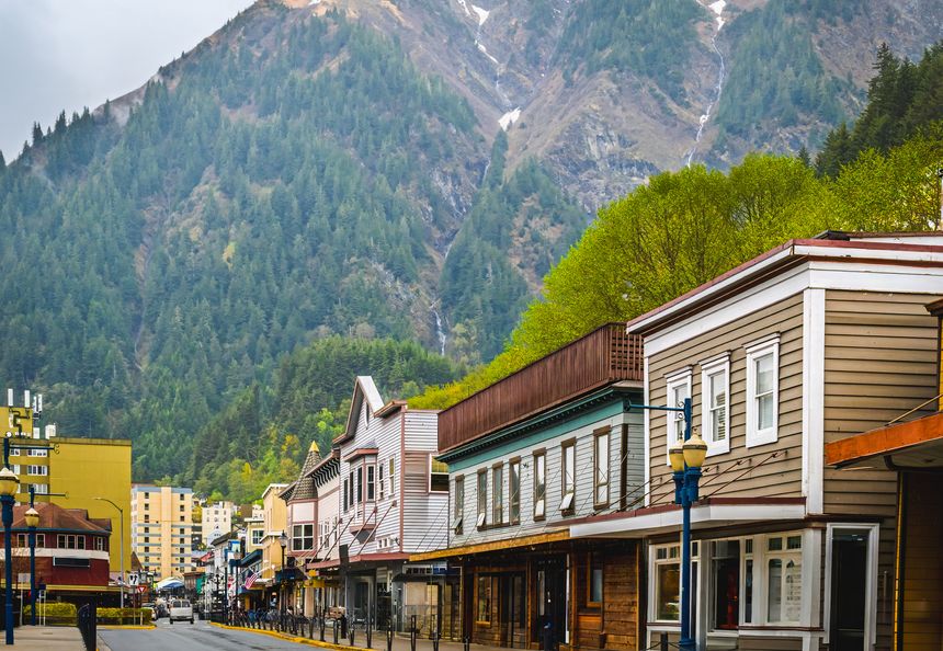View of street in downtown Juneau, Alaska, on spring day; mountains in background