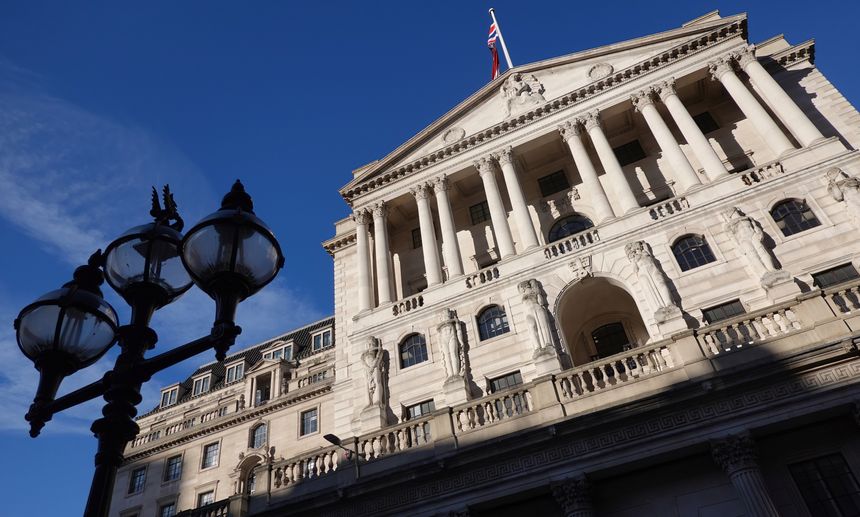 A low angle view of the Bank of England, the British Central Bank, in Threadneedle Street, London against a blue sky background.
