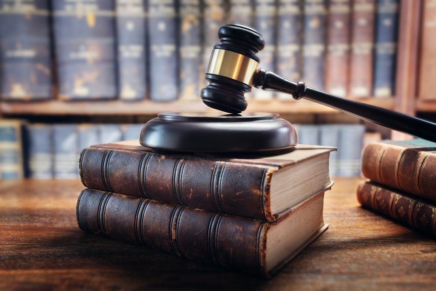 Judge gavel and law books in court, law and justice background concept