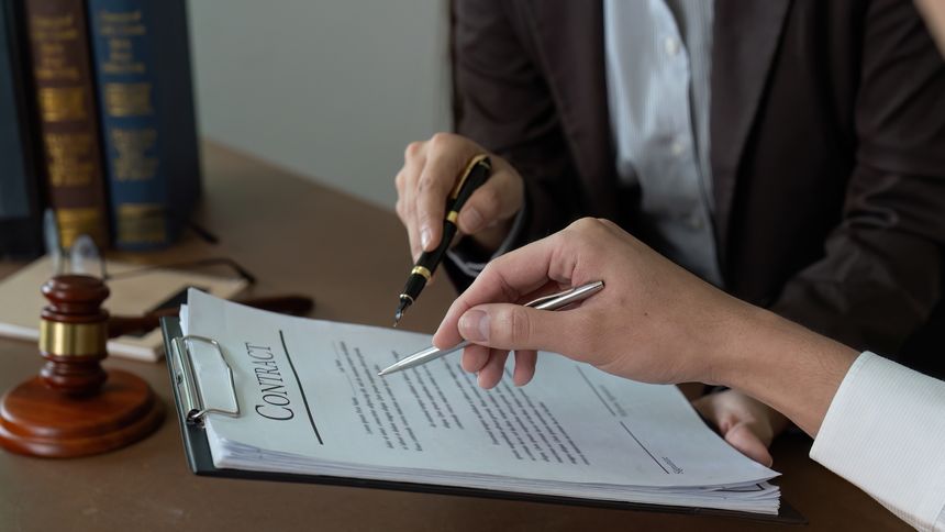 A lawyer and client examine a contract, highlighting the importance of clarity and understanding in legal agreements.