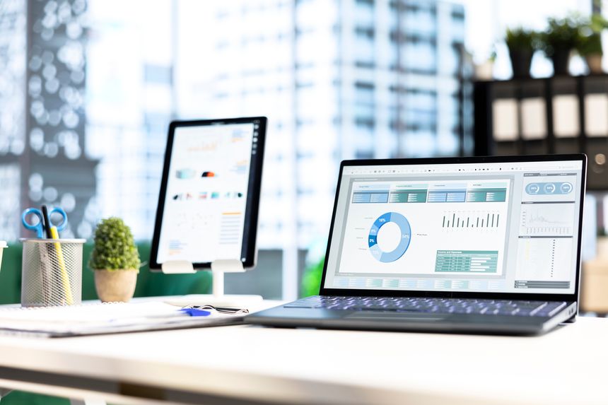 Modern work environment in a urban corporation downtown building, high end workspace with business analytics trends running on screen. Career development, office life. Close up.