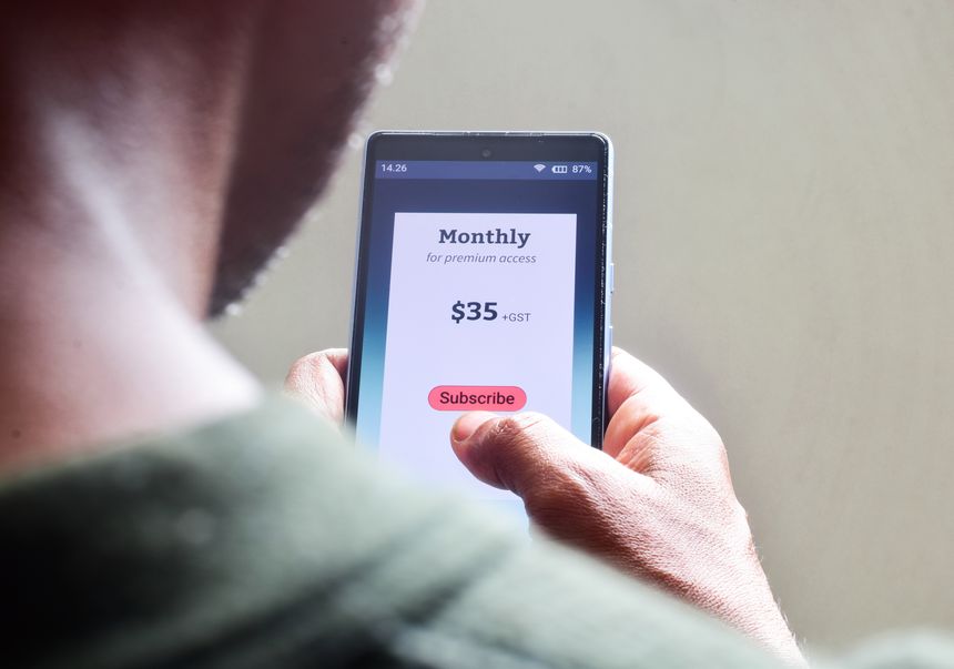 Man managing monthly subscription plan for streaming service or educational program or delivery benefits on his smartphone. selective focus.