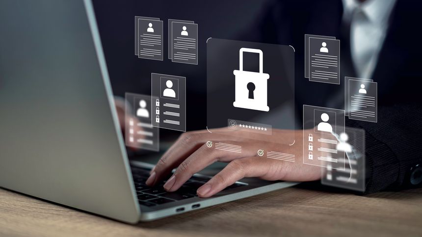 Management confidentiality and employee verification concept with businessman using laptop, reviewing secure digital documents and protected user data in a confidential business system interface.