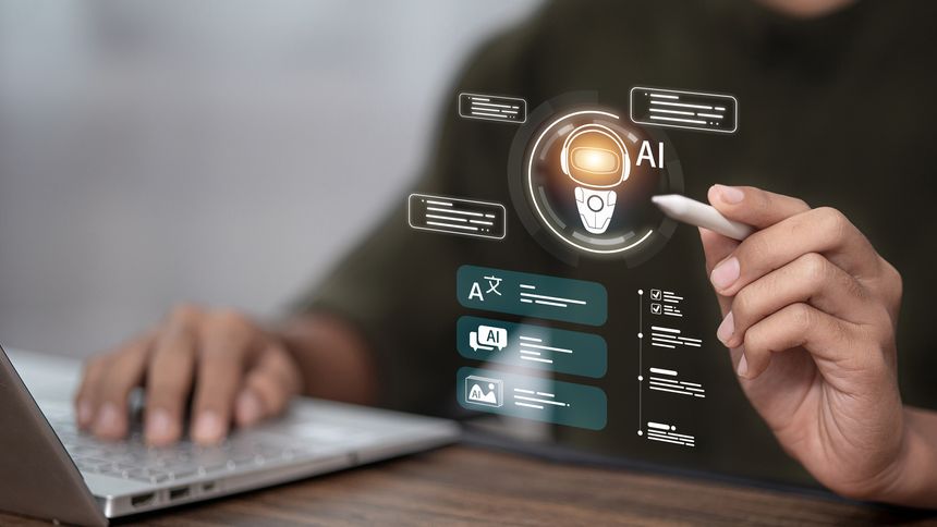 Person using laptop and stylus with AI interface, representing artificial intelligence, automation, and digital productivity in modern technology.