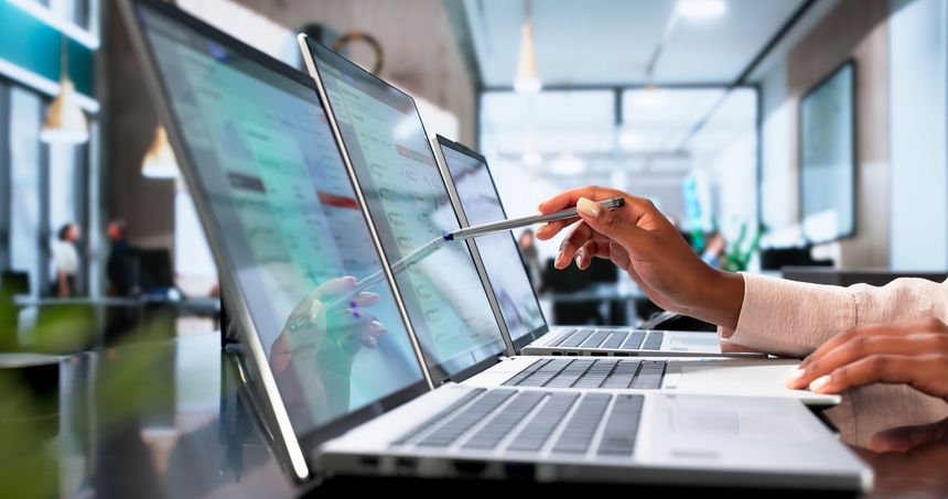 Young Compliance Officer Reviews Real-time Alerts For AML Risk Screening.