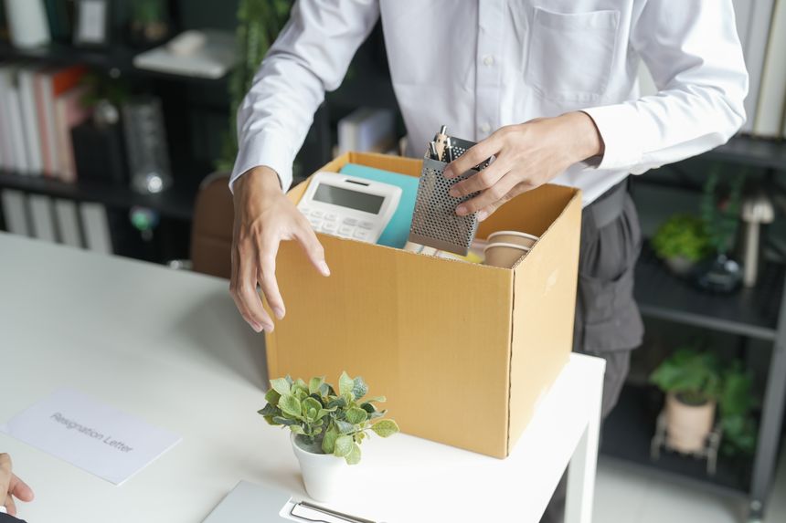 Business man sending resignation letter and packing Stuff Resign Depress or carrying business cardboard box Change of job or fired from company resign