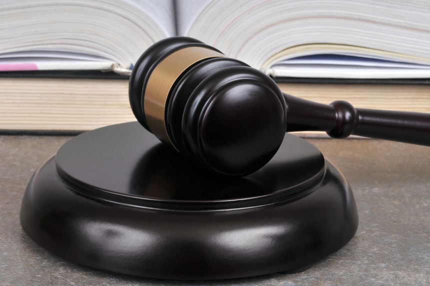 Close-up judge gavel with books in the background