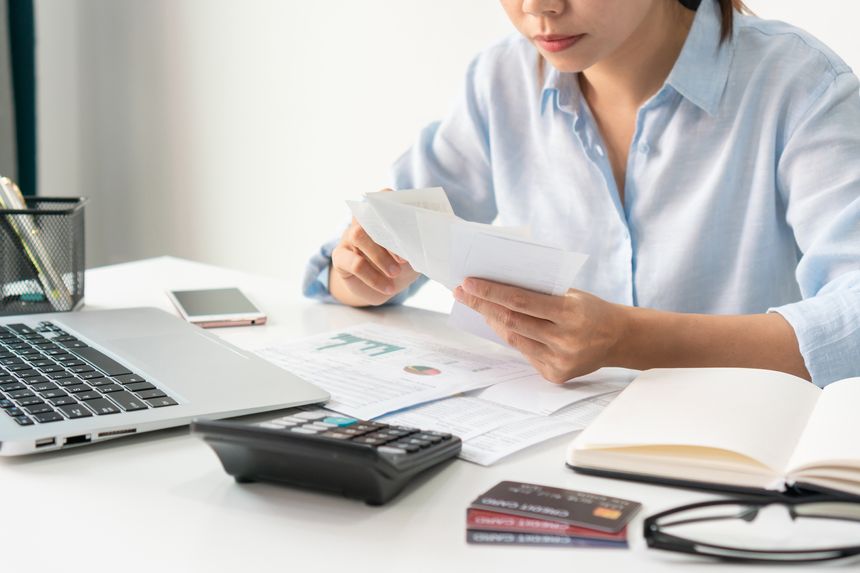 Stressed Asian woman get trouble by calculating monthly expenses at home. Financial problem