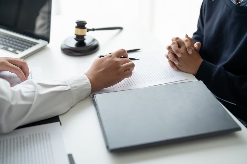Lawyer businessman workingÂ with lawbook in officeÂ or courtroom Legal counsel with gavel and legal law. justice and lawyer concept Judge gavel hammer on Lawyer desk