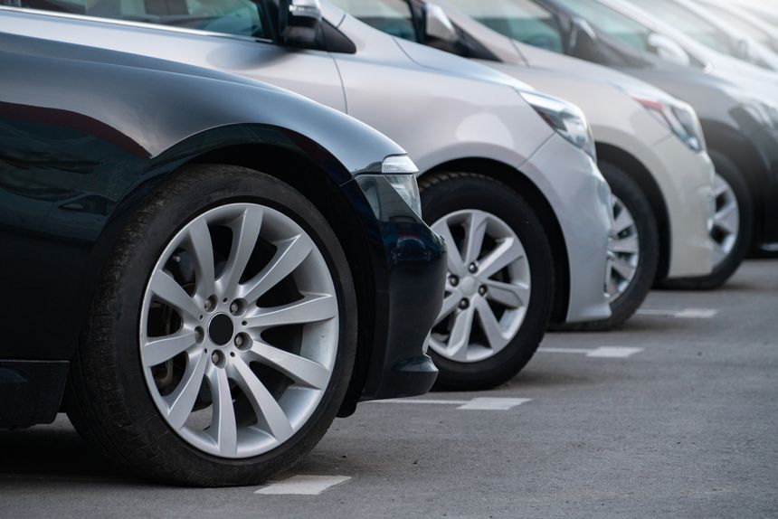 A lot of cars in a rows. Used car sales.