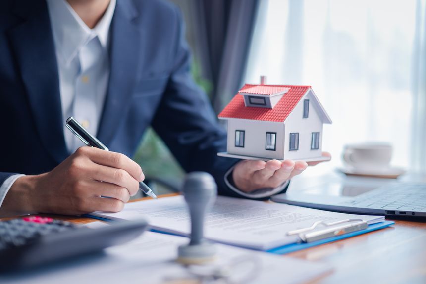 Businessperson decided to buy new home, securing loan to finance property and obtaining insurance for house, with the real estate agent facilitating sale and handing over home key. insurance, estate.