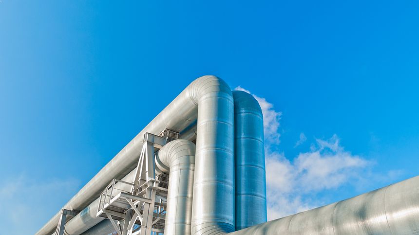close-up of a pipeline against a blue sky.