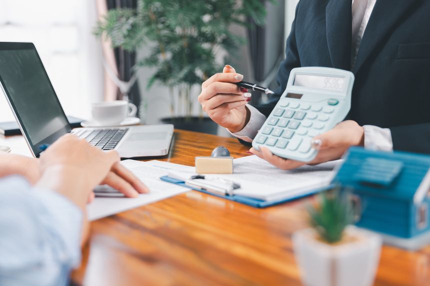 Bank approve loan to buy home concept. Real estate agent talked about terms of home purchase agreement, asked customer to sign documents to make contract legally. approved mortgage application form.