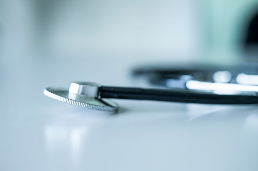 Close up of stethoscope on grey desk. Heatlhcare concept