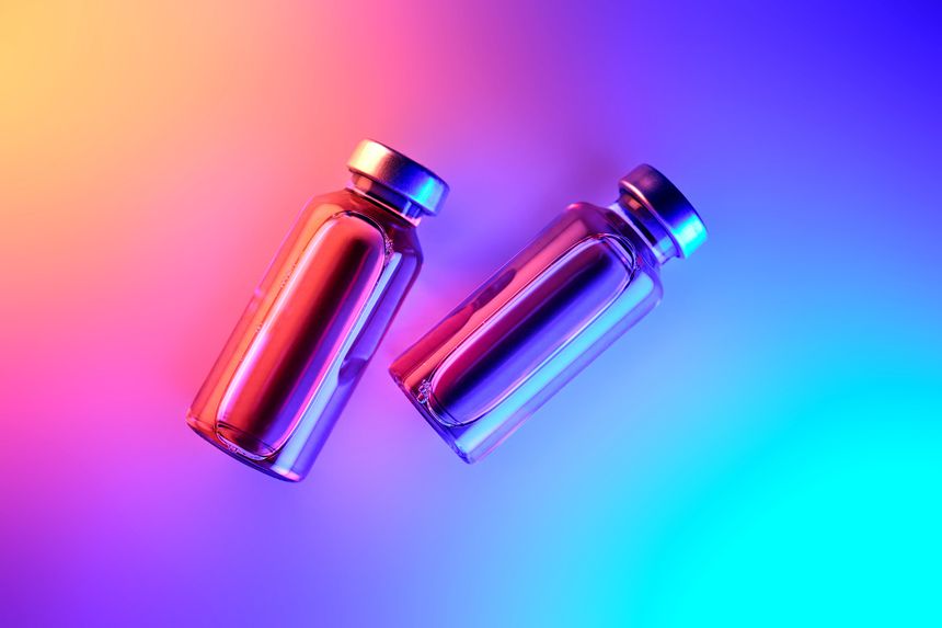 Two medical vials containing anti obesity drug formulations and peptide based metabolic therapy solutions, representing weight loss research and diabetes treatment innovations in a clinical setting