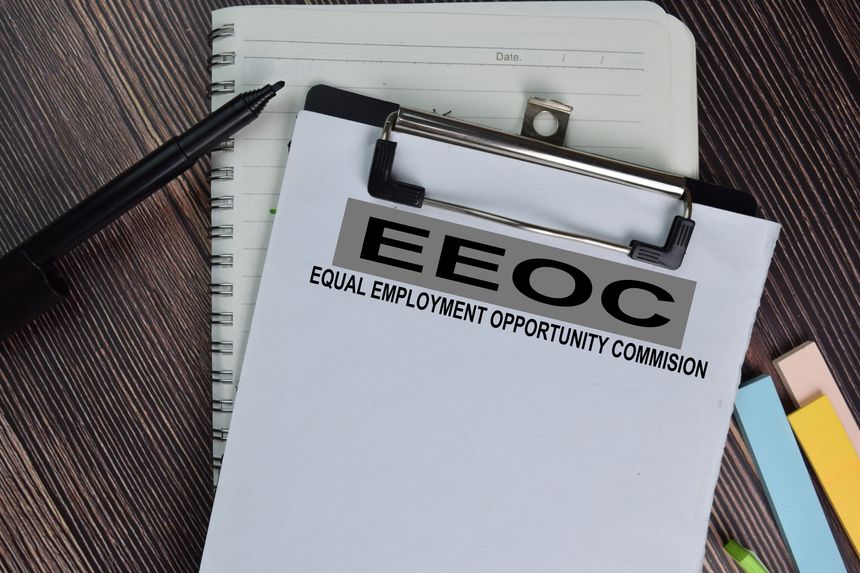 Equal Employment Opportunity Commission (EEOC) text on Document form isolated on office desk.
