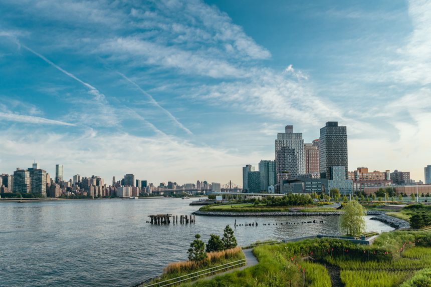 Long Island City residential buildings in the early hot summer morning. Modern neighbourhood. Beautiful green Gantry park