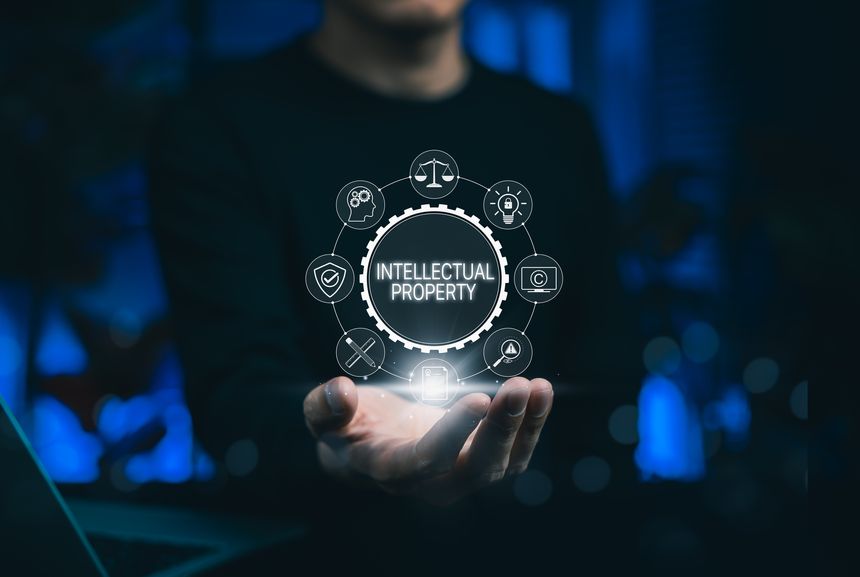 Intellectual property protection concept with businessman showing digital icons for copyright, patent, trademark, and legal rights, emphasizing innovation security in digital technology business.