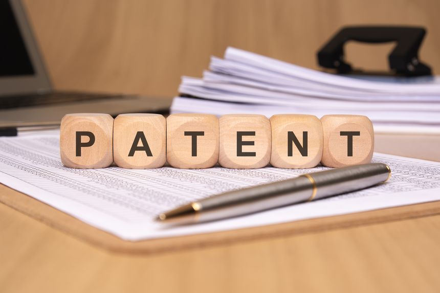 An organized workspace that prominently features various patent paperwork, symbolizing innovation and legal protection