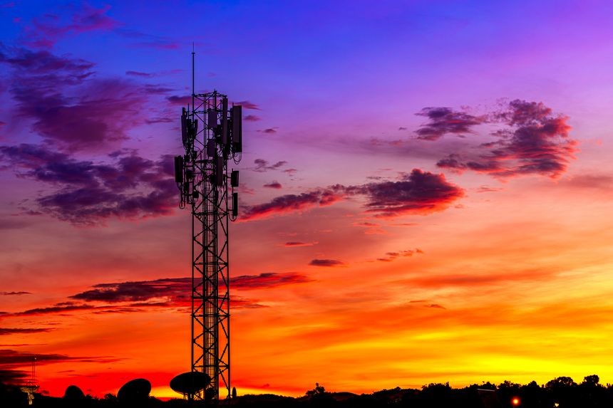 Telecommunication towers with colorful sky as a backdrop in the morning and sunlight reflecting off clouds create a stunning and mesmerizing light effect. Concept of innovation, technology and environment.