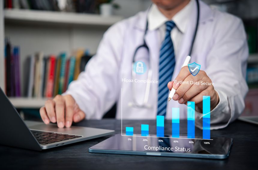 HIPAA, compliance Doctor uses tablet and laptop patient data security and privacy in EHR, charting audit, governance, and encryption progress toward 100%. concept healthcare protection workflow.