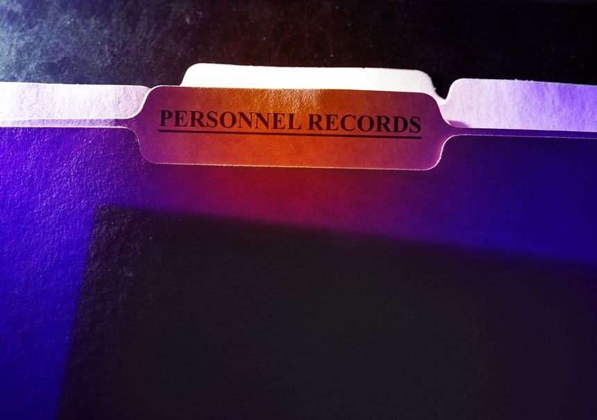 Personnel Records folder with visible document inside -- employee privacy concept