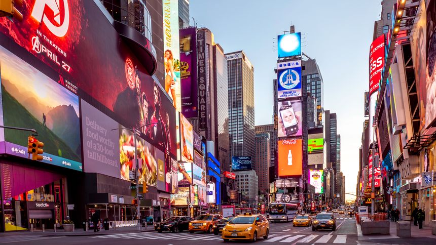 New York, NY, USA - October 10, 2025: view of the iconic New York city in the USA showcasing Manhattan at Times Square at night with tons of lights and tourists passing by.