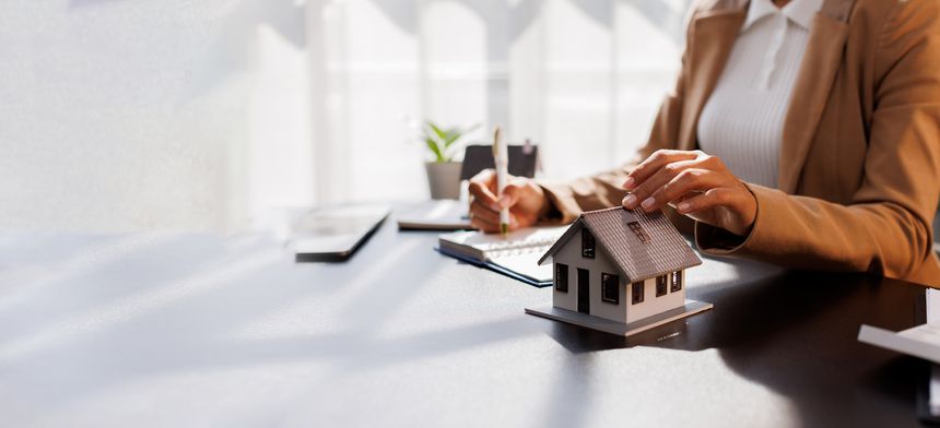 Real Estate Broker agent's signature on the contract finalized the mortgage agreement, marking a significant investment in the housing property for business purposes. Homework