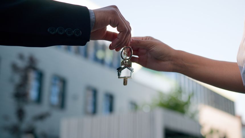 Close up male female hands shaking unrecognizable real estate agent seller trader developer woman give bunch of keys to man client rental buyer homeowner real estate business loan handshaking in city agreement. High quality 4k footage