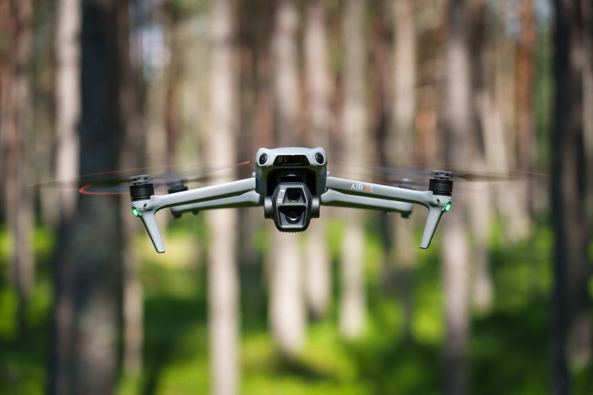 Kotka, Finland - July 26, 2025: DJI Air 3S drone in the forest, front view close-up.