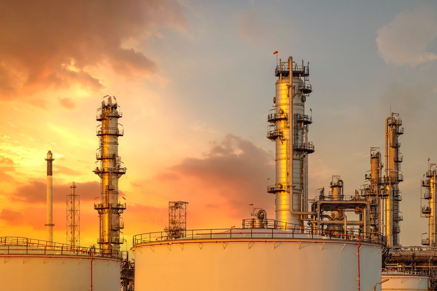 majestic petrochemical oil refinery plant glows under power full sky as industrial chimneys and towers release steam, showcasing energy technology and petroleum production for the fuel industry