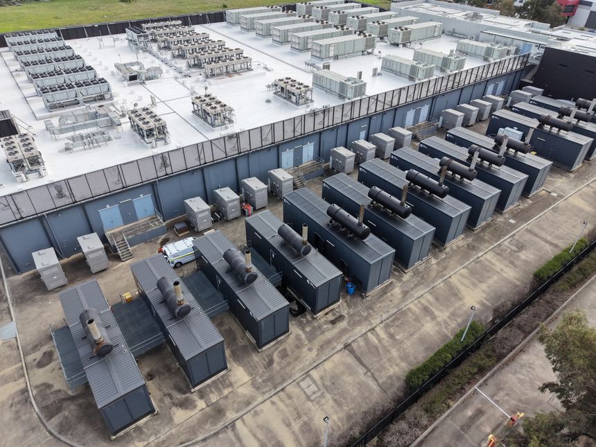 Large data center facility showing cooling units and rows of backup generators