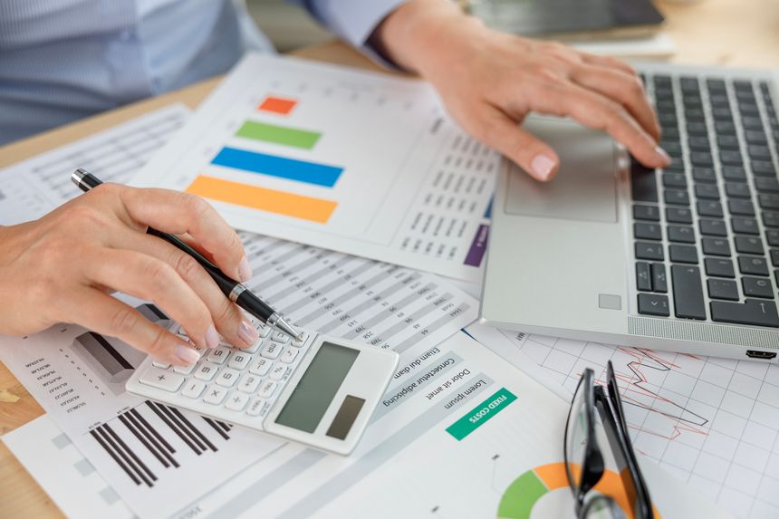 Businesswoman financial planning and making accounting database report at workplace