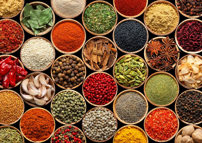 Set of different aromatic spices in bowls on black background, flat lay